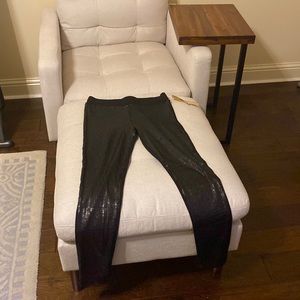 Black sequined leggings on front and nylon/polyester on back.